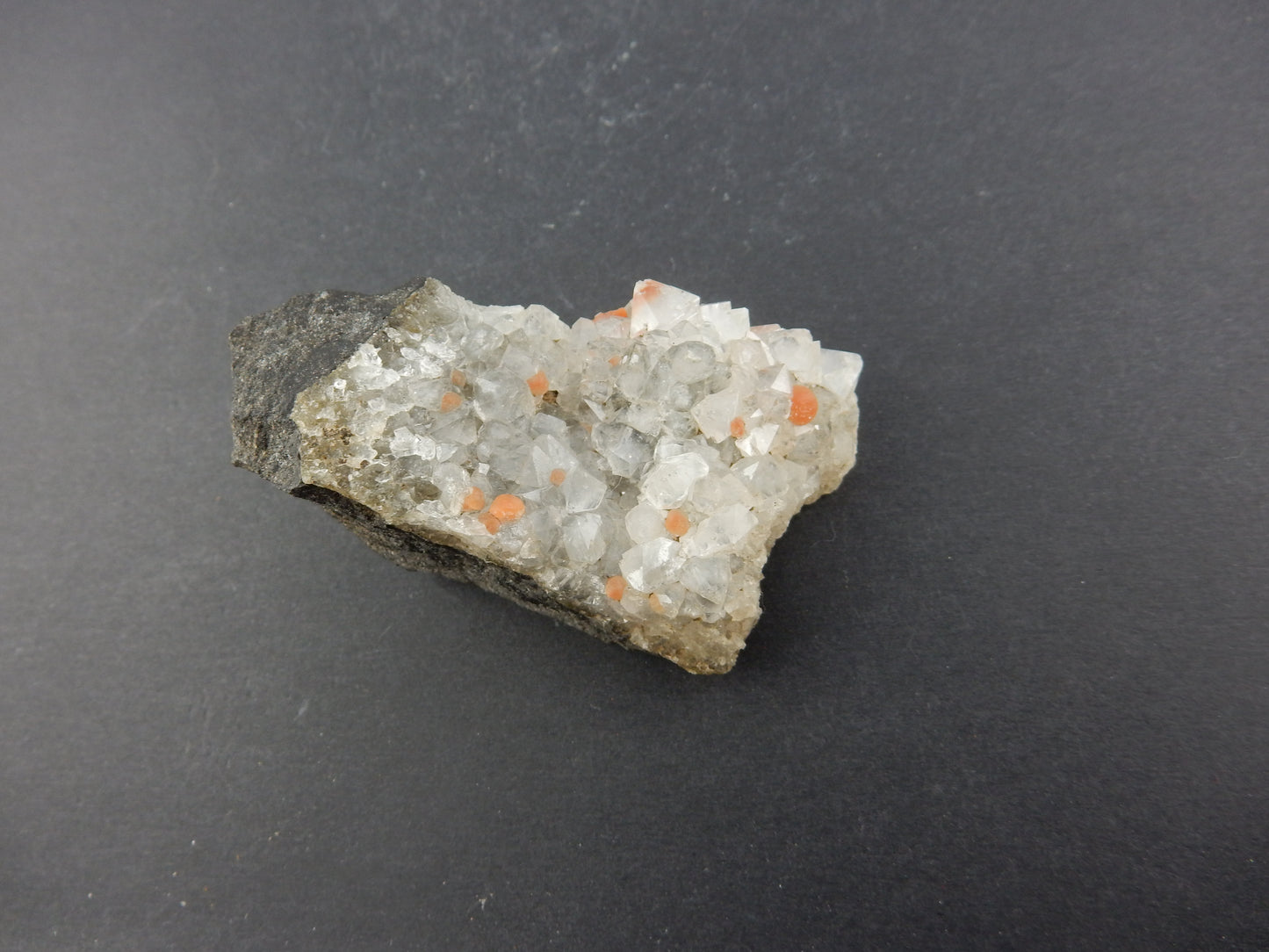 Rare botryoidal form of fluorite - red balls on plate of gemmy quartz crystals