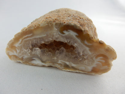 Unique cute little agate geode with "wispy" swirls at entrance and sparkly terminated quartz inside