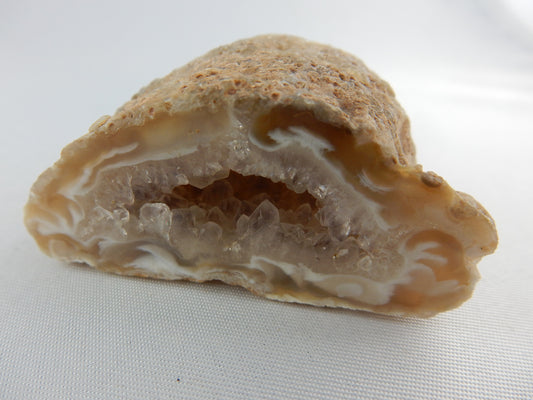 Unique cute little agate geode with "wispy" swirls at entrance and sparkly terminated quartz inside
