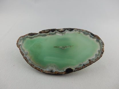 Polished gemmy slab of full round of agate - deep green
