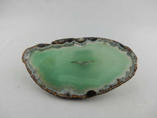 Polished gemmy slab of full round of agate - deep green