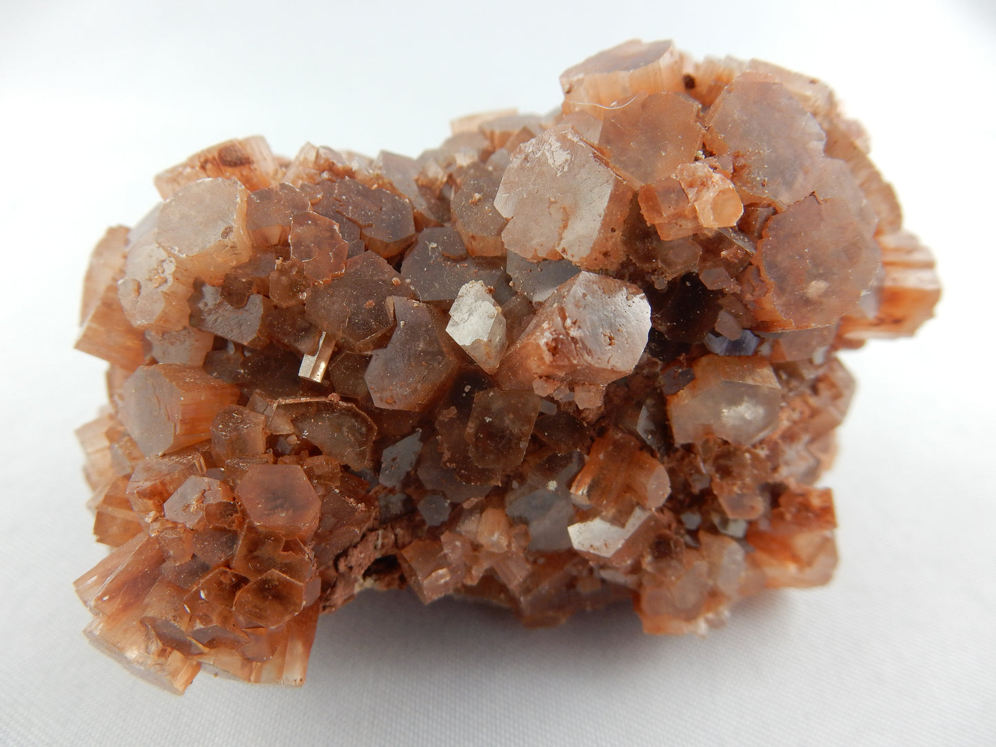 "Floater" crystal of orange aragonite formed in deserts of China