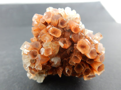 Complete "floater" of rust-orange and clear-white columns of aragonite formed into a ball in the desert