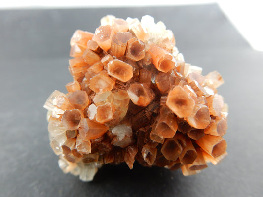 Complete "floater" of rust-orange and clear-white columns of aragonite formed into a ball in the desert