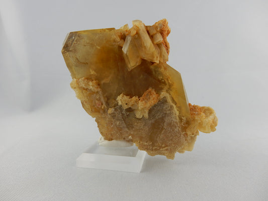 Heavy amber gemmy top termination "blade" with associated calcite/quartz