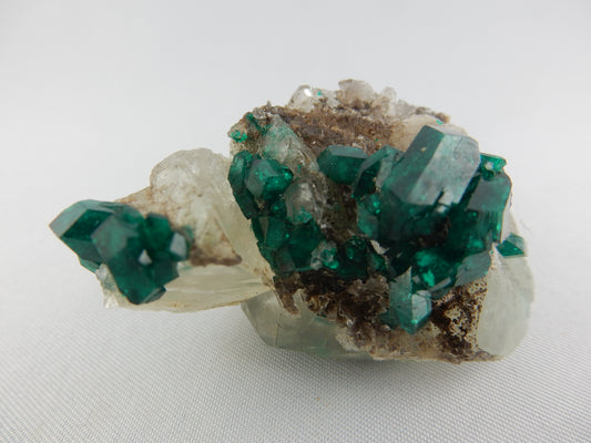 big gemmy intense emerald-green perfectly terminated multiple crystals of Dioptase on quartz matrix