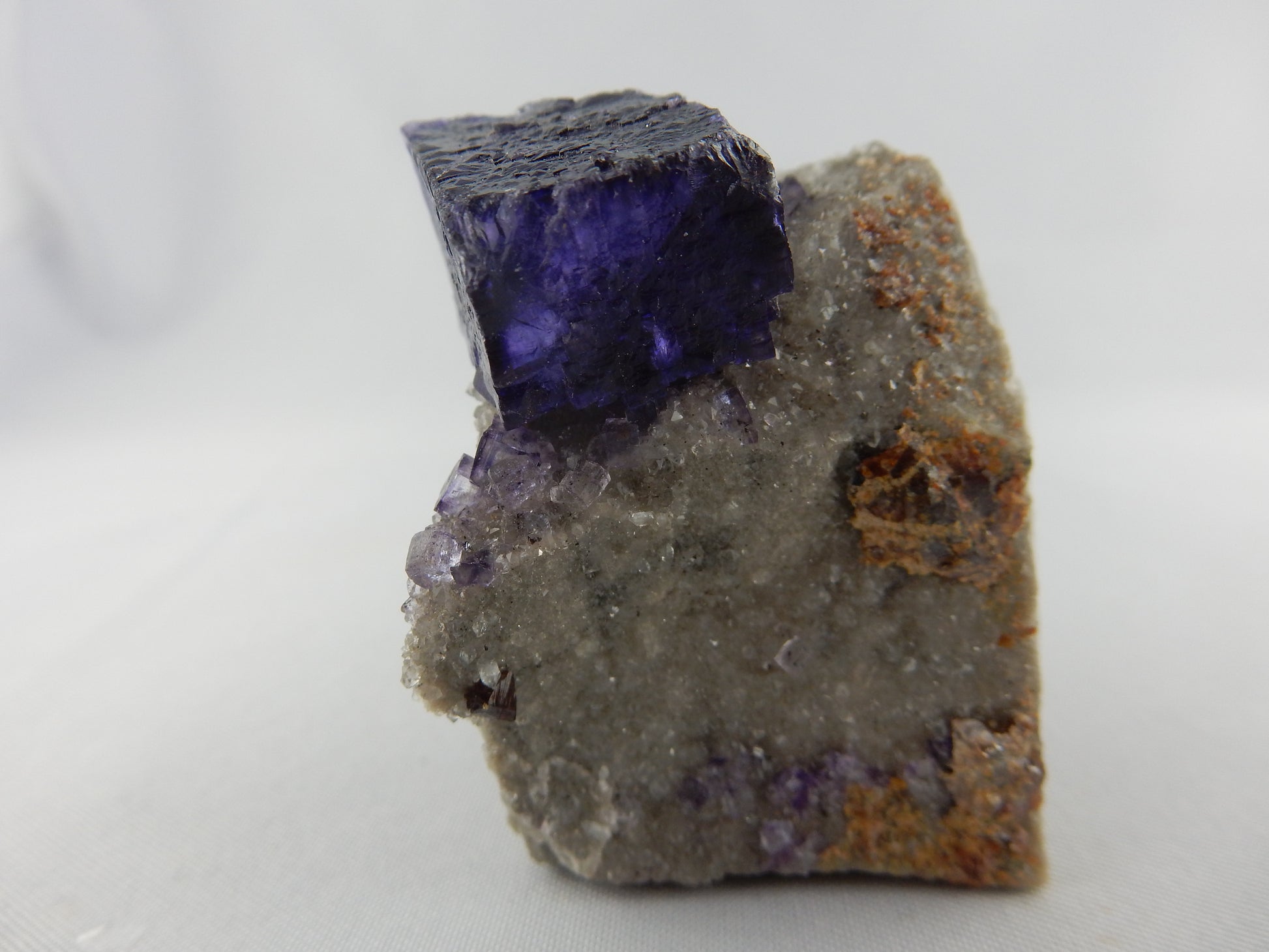 Fluorite - classic "etched dissolution" single modified deep purple phantom gemmy cubic crystal perched on bed of dolomite - Elmwood Mine