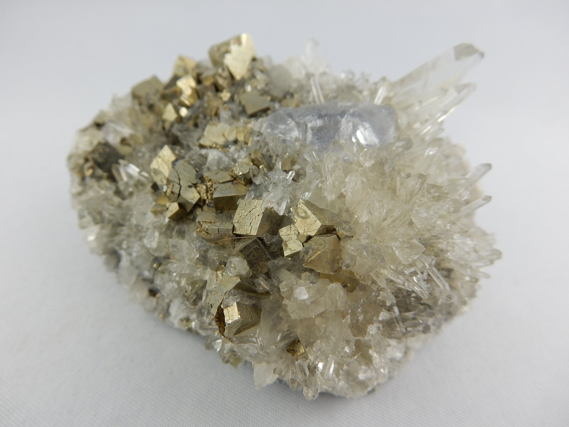 Interesting combo specimen - gemmy purple fluorite nestled in a bed of bright pyrite with a scattering of gemmy needle quartz