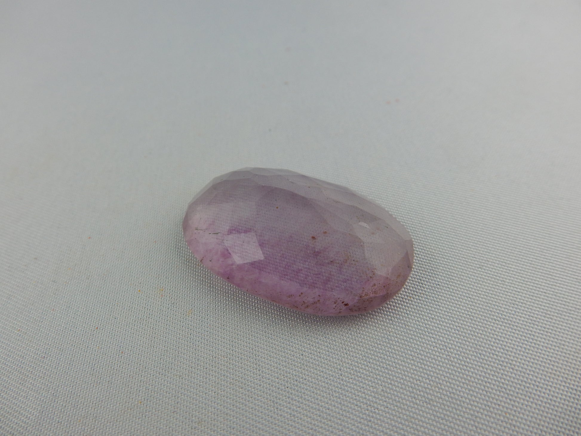 faceted cab of gemmy purple-blue-yellow banded fluorite