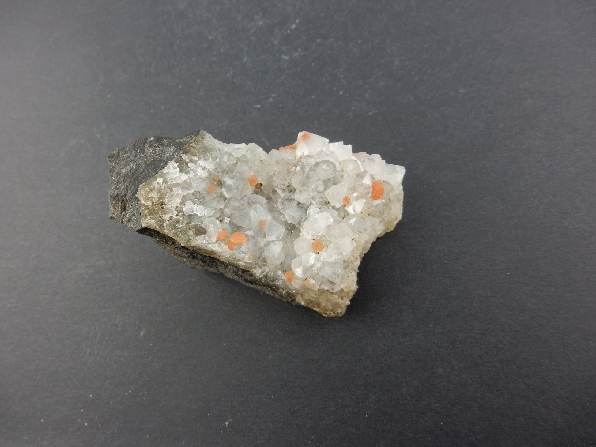 Rare botryoidal form of fluorite - red balls on plate of gemmy quartz crystals