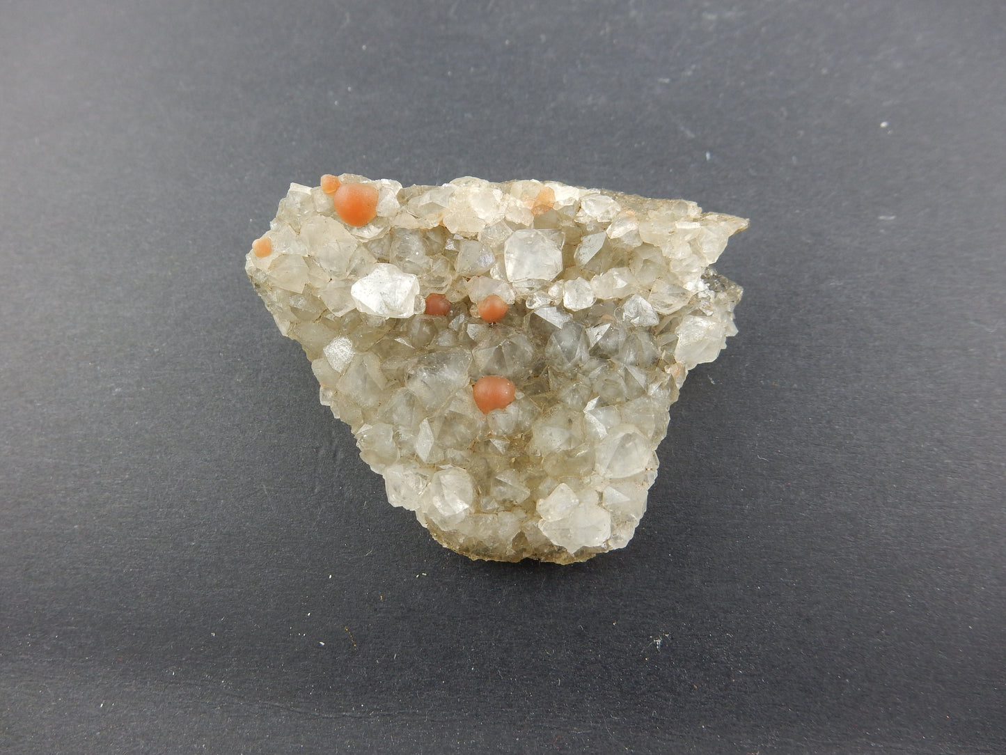 Rare botryoidal form of fluorite - red balls on plate of gemmy quartz crystals