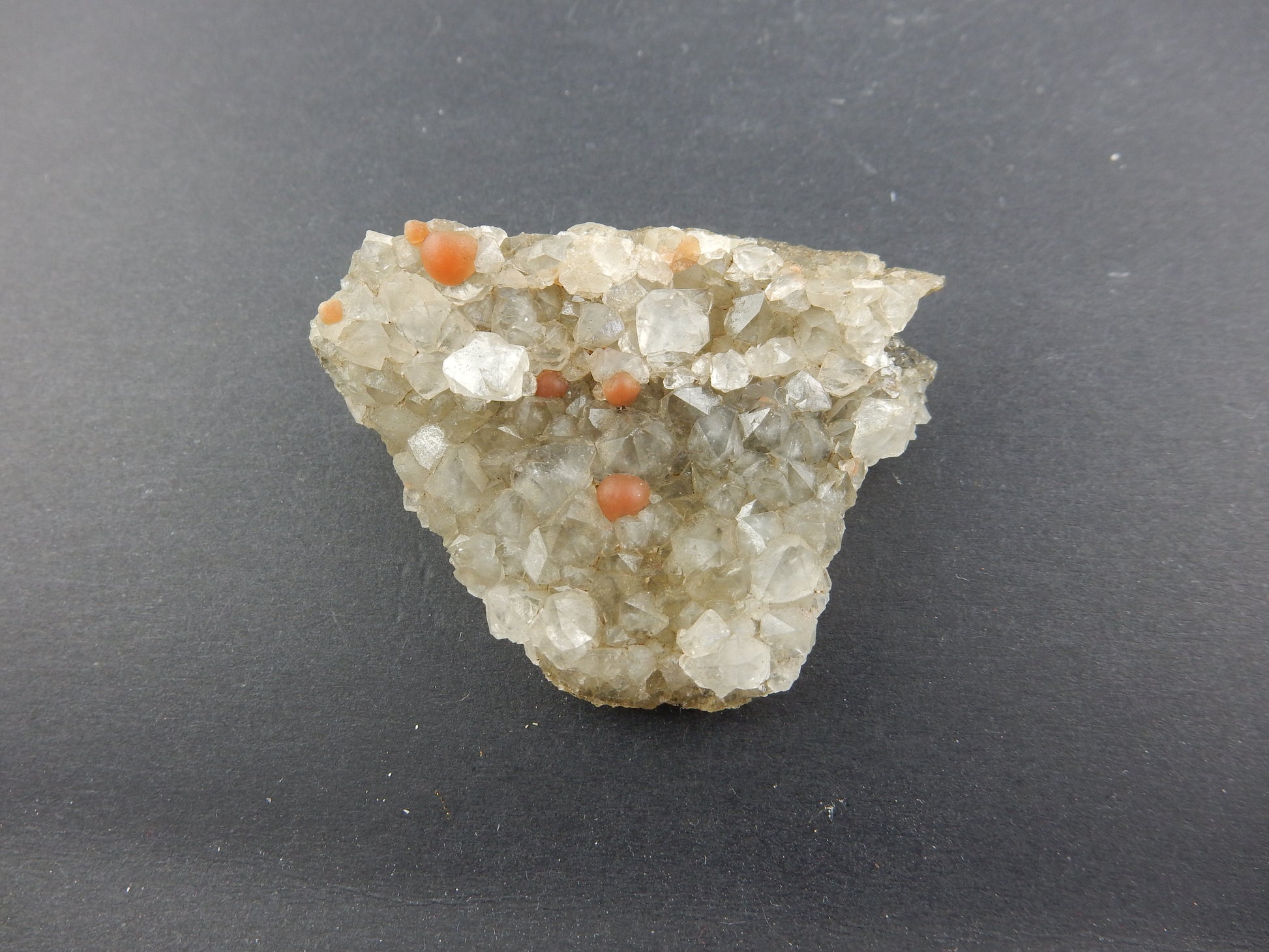 Rare botryoidal form of fluorite - red balls on plate of gemmy quartz crystals