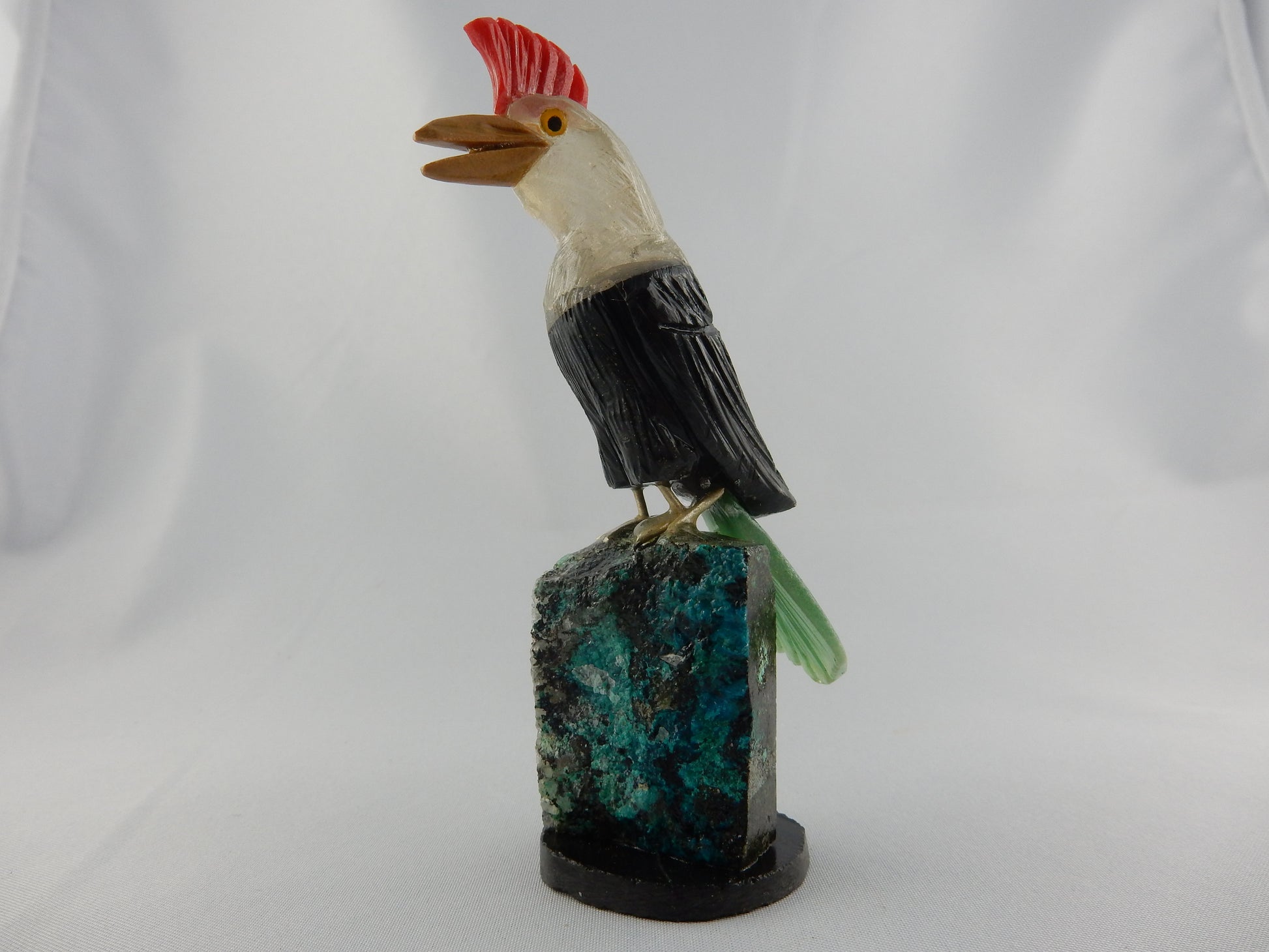 red agate crest, quartz head, black onyx body, green adventurine tail - perched on chrysocolla base