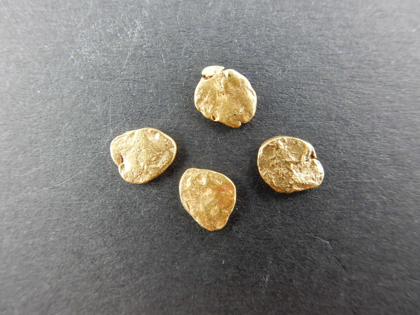 perfectly matching round flakes of pure gold