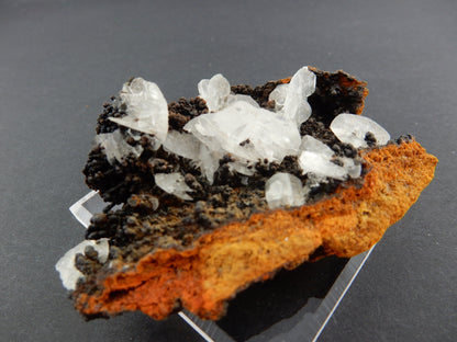 clear gemmy blades of Hemimorphite nicely contrasted on a bed of dark hematite