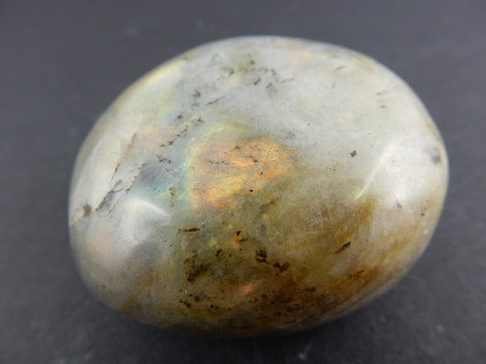 polished oval of iridescent "labradorescence" of orange-red-green-blue feldspar