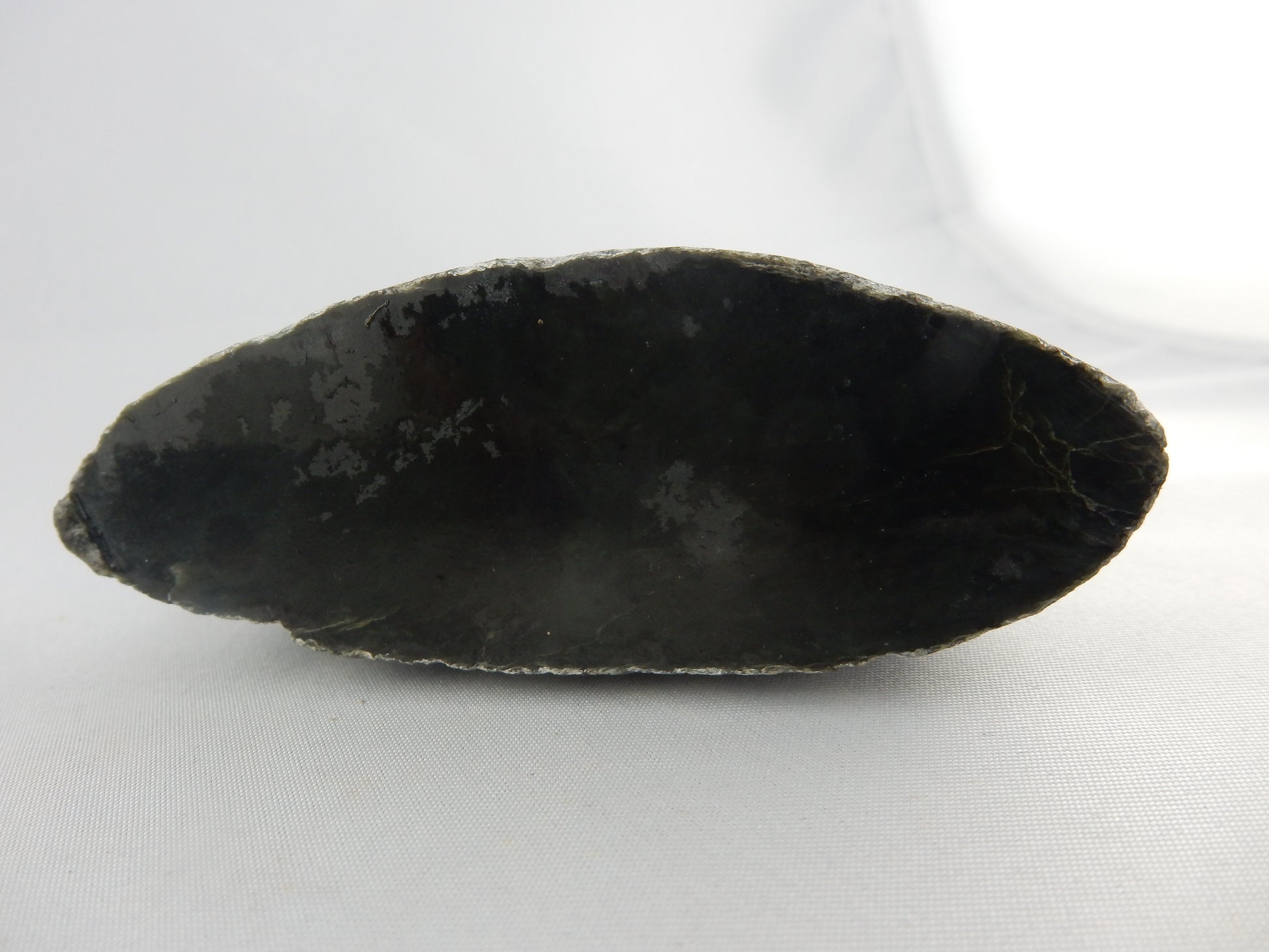 Half a small flattened boulder specimen (or polishing raw) of dark NZ "Kawakawa" - classic white "skin" - part natural stream worn/part cut/polished