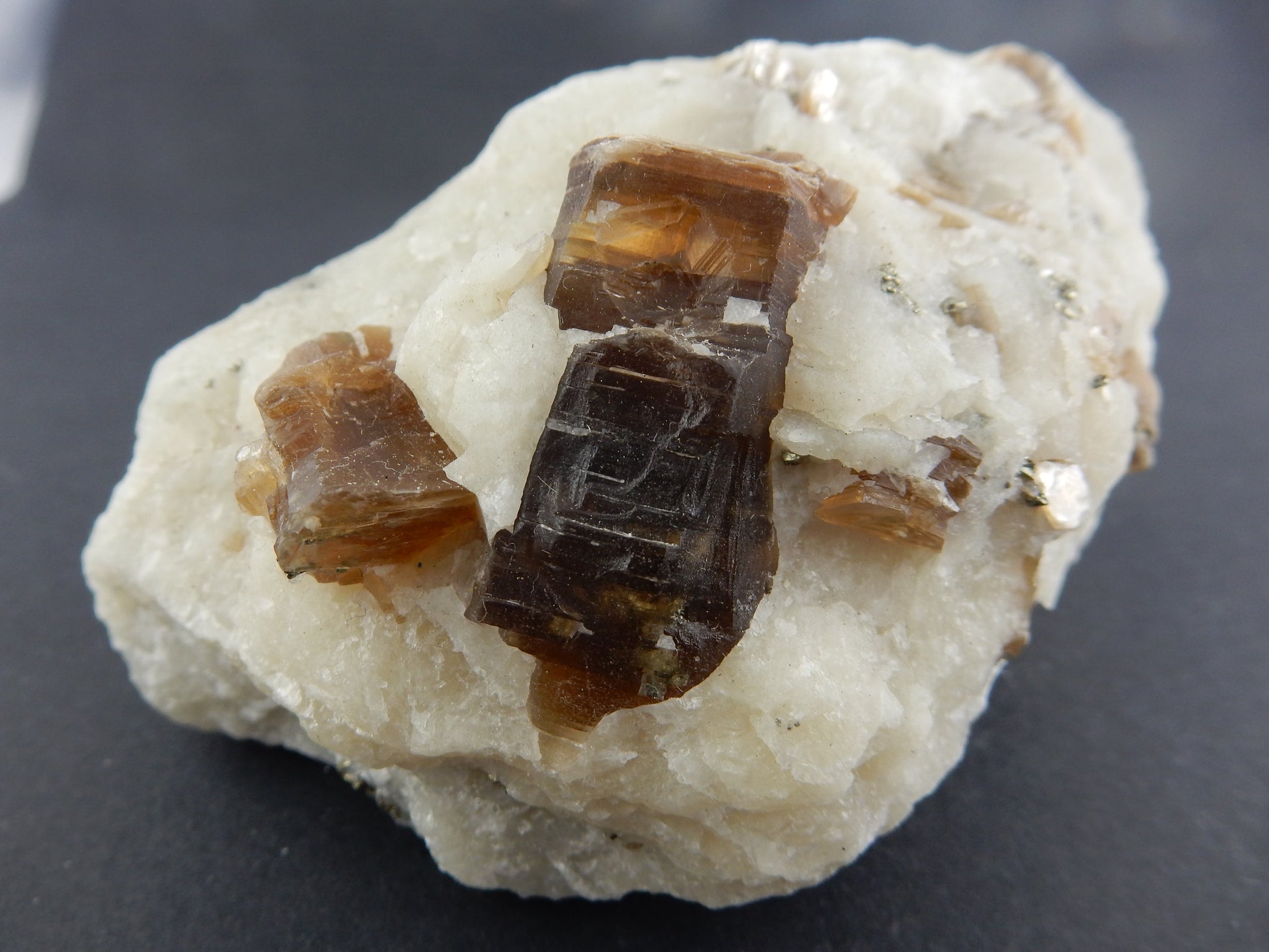 Very large (rare) stacks of brown phlogopite mica on white marble