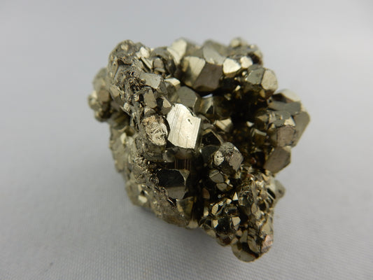 bright shiny cubic and dodeahedron cluster of Pyrite