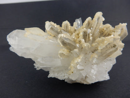 showy radiating cluster of many terminated quartz crystals - "coated" one side with Ankerite - with a few double-term calcites also