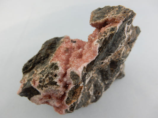 Rhodochrosite - big showy specimen of sparkly pink druse on matrix of black basalt