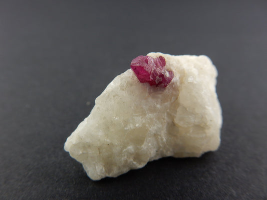 perfect terminated octahedral Spinel blood-red crystal on white marble for showy display