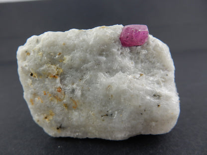 nice gemmy-blocky terminated RUBY RED crystal (strong UV) on bed or white marble and shiny Phlogopite mica