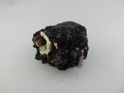 Very rare purple sapphire (corundum) terminated point (and 2 other small) in matrix of black biotite and sphalerite
