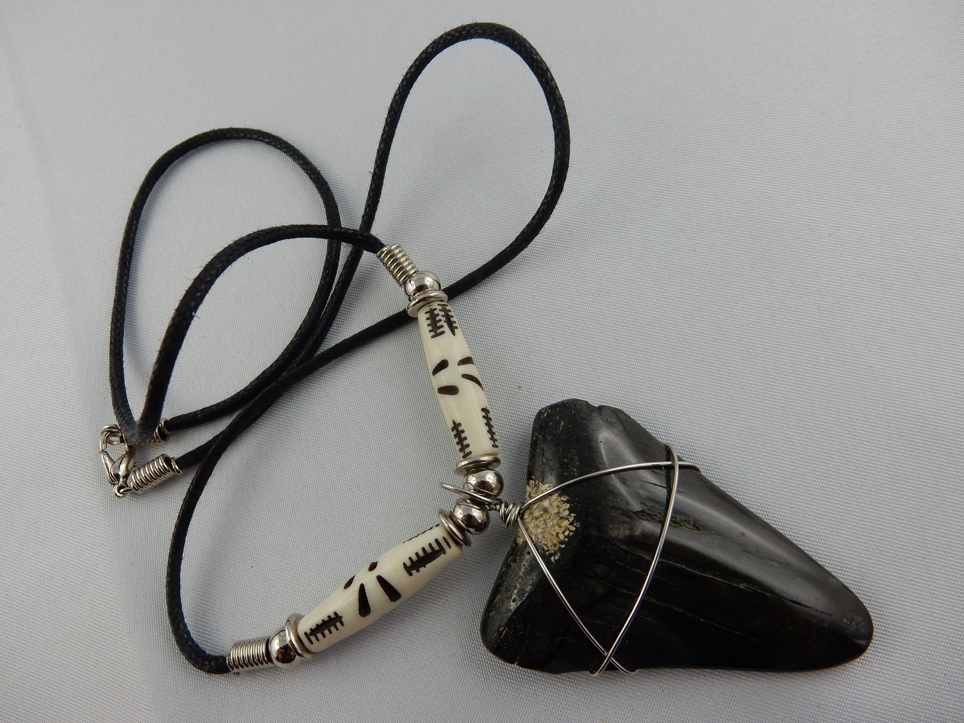 mean black big tooth of ancient megladon shark - white/black beads on black leather necklace - 30 million years old - necklace