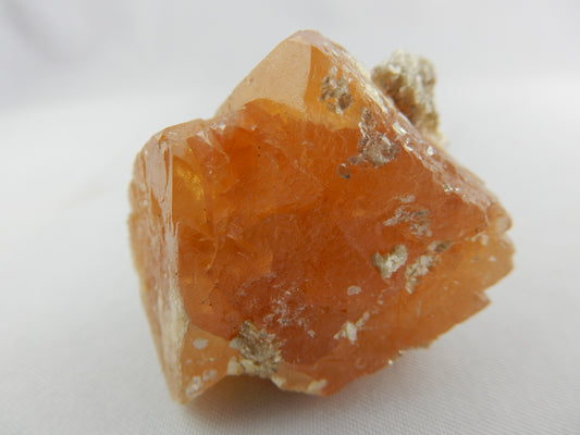 gemmy orange octahedron "floater" cluster of Scheelite with muscovite skin