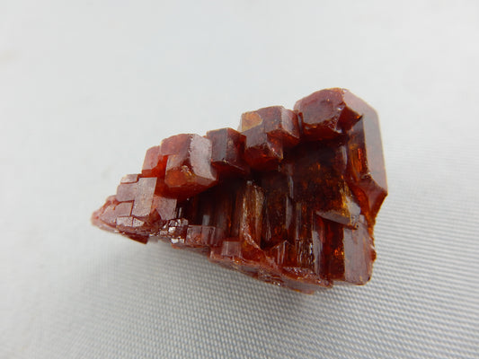 Gemmy - red-orange terminated triangular "floater" repeated hexagons in an interesting hollow "stack" cluster