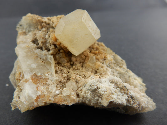 Single terminated yellow-tan crystal on matrix